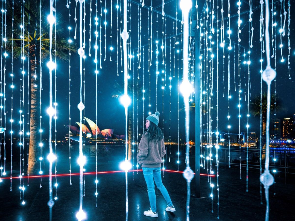 An immersive light installation with the Sydney Opera House in the background.